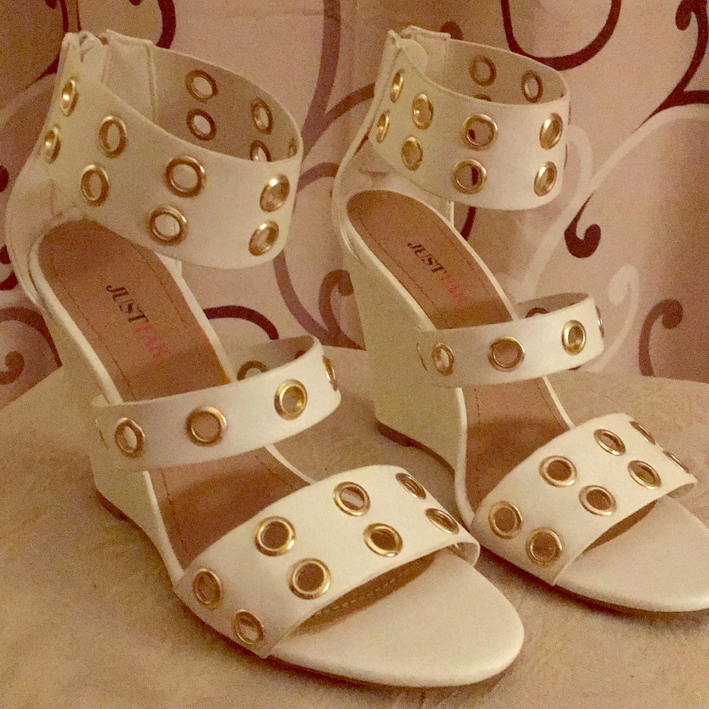 White wedge heels with gold tone grommet design.